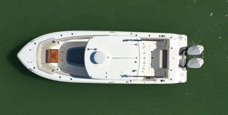 Slide: The Image of Aerial view of 2022 Boston Whaler 330 Outrage boat on green water. - 5