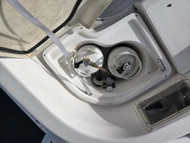 Slide: The Image of 2002 Hunter 356 boat fuel tank compartment with visible connections and fittings. - 17