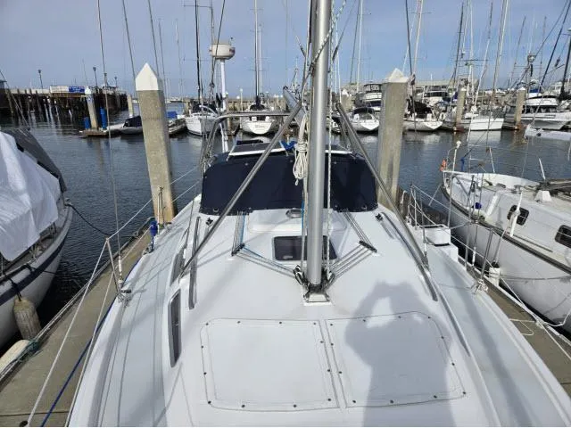 Slide: The Image of 2002 Hunter 356 sailboat docked in marina, surrounded by other boats. - 20