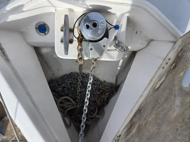 Slide: The Image of Anchor chain and windlass on a 2002 Hunter 356 sailboat deck. - 21