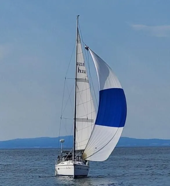 Slide: The Image of Sailboat Hunter 356 (2002) with blue and white spinnaker on open water. - 28