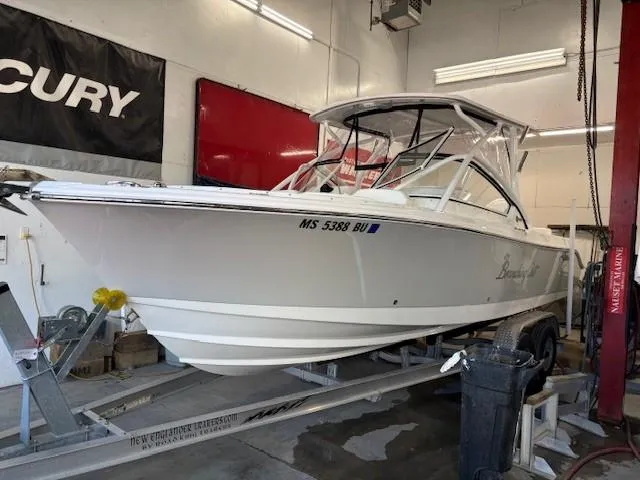 Slide: The Image of 2023 Edgewater 248 CX boat on trailer in a garage setting. - 10