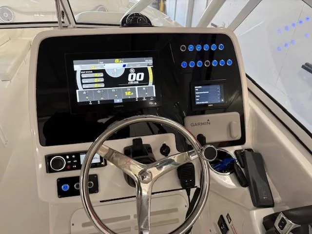 Slide: The Image of 2023 Edgewater 248 CX boat dashboard with Garmin navigation system and modern controls. - 5