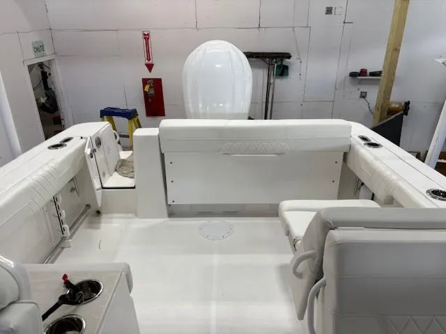 Slide: The Image of 2023 Edgewater 248 CX boat interior with white seating and modern design. - 6