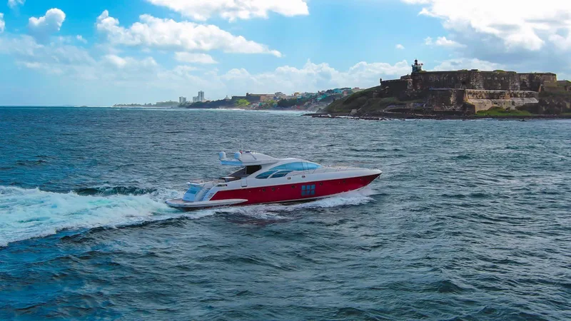 The Image of 2010 Azimut 86S yacht cruising near a coastal fortress under a bright blue sky. - 1