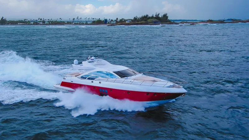 Slide: The Image of 2010 Azimut 86S yacht cruising on open water, showcasing sleek design and vibrant red hull. - 15