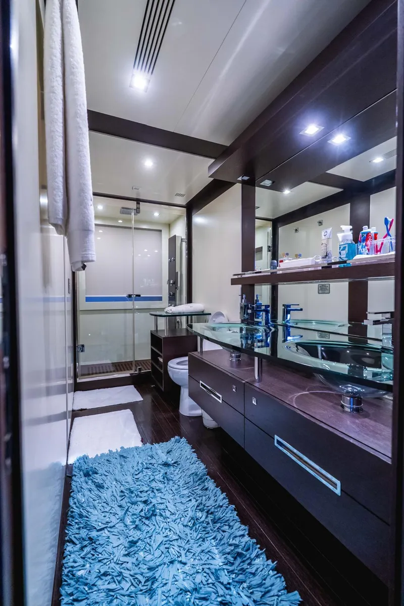 Slide: The Image of Luxurious bathroom on 2010 Azimut 86S yacht with modern fixtures and blue rug. - 24