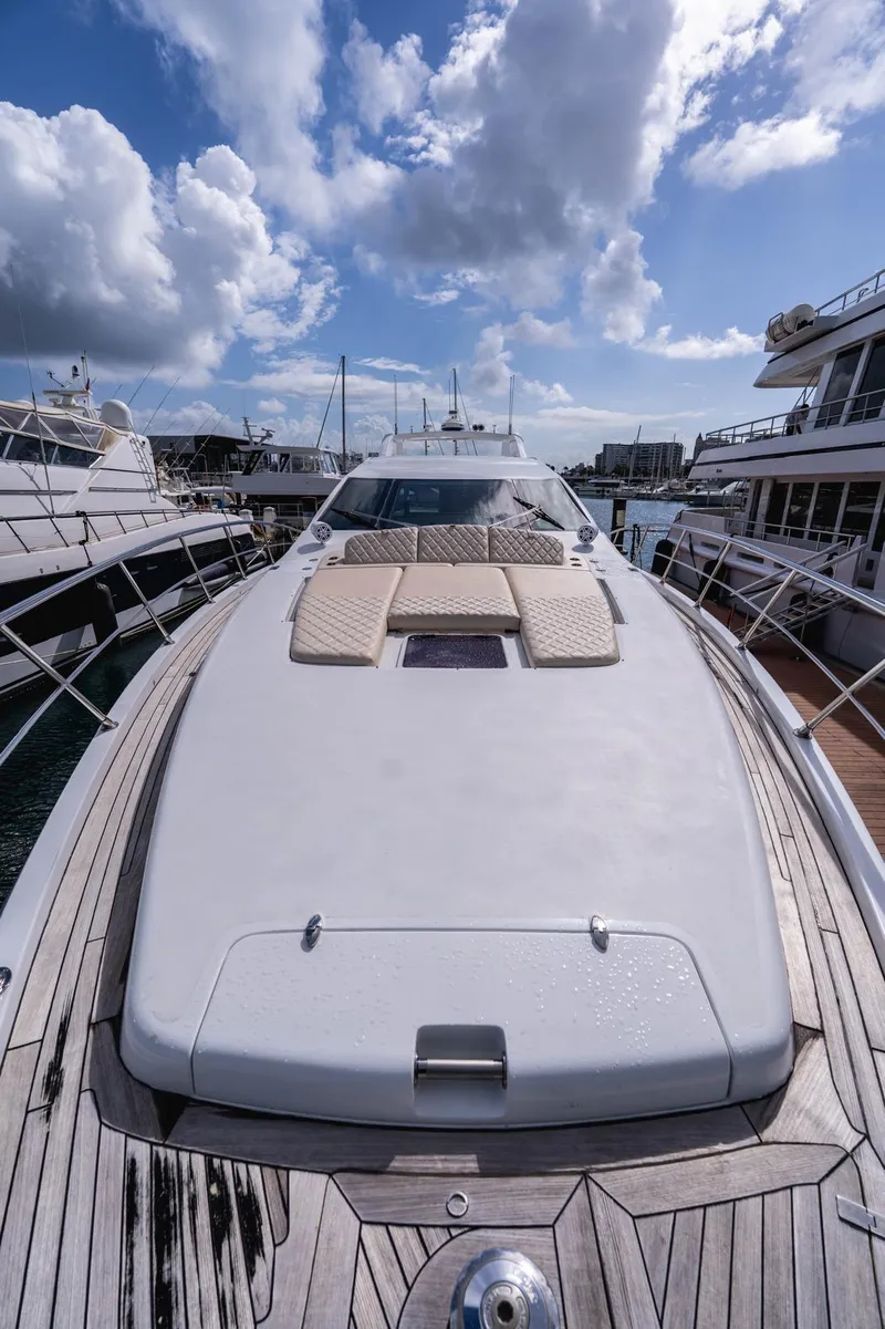 Slide: The Image of 2010 Azimut 86S yacht with sleek deck design under a partly cloudy sky. - 25
