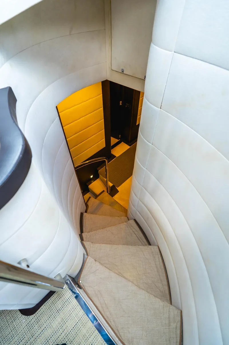 Slide: The Image of Spiral staircase inside 2010 Azimut 86S yacht, featuring elegant white paneling. - 3