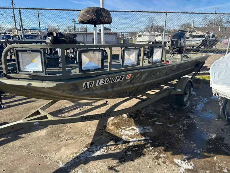 Slide: The Image of 2016 Tracker Grizzly 1760 MVX Sportsman boat on trailer, parked outdoors. - 2