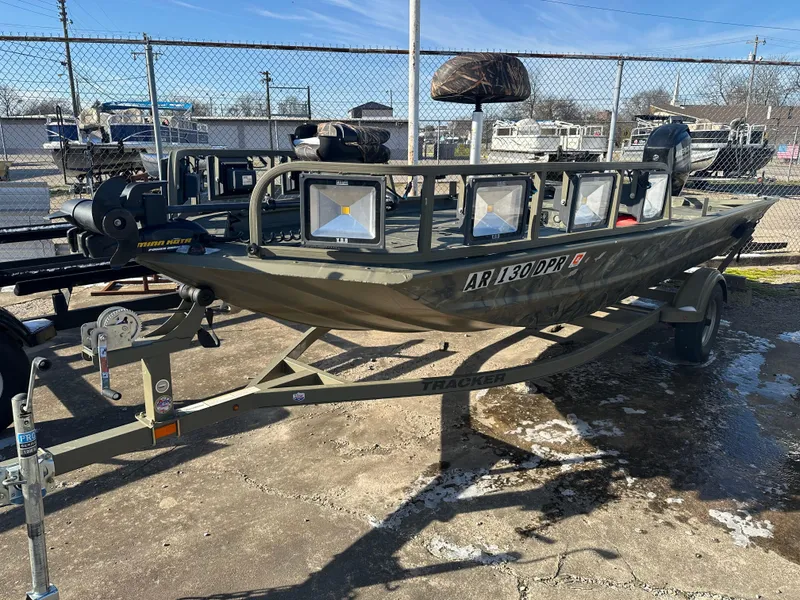 Slide: The Image of 2016 Tracker Grizzly 1760 MVX Sportsman boat on trailer, parked outdoors. - 3