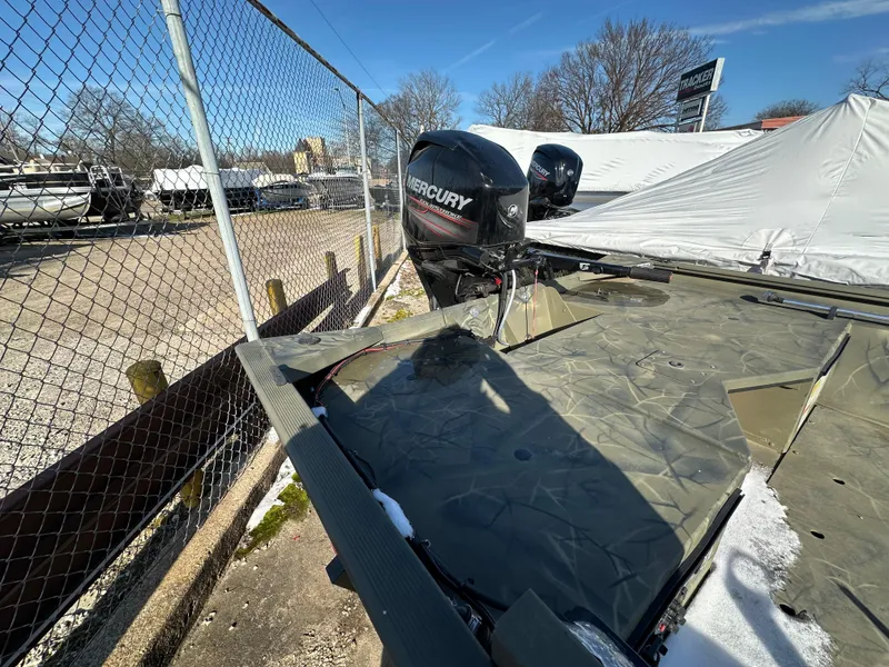 Slide: The Image of 2016 Tracker Grizzly 1760 MVX Sportsman boat with Mercury engine, parked outdoors. - 4