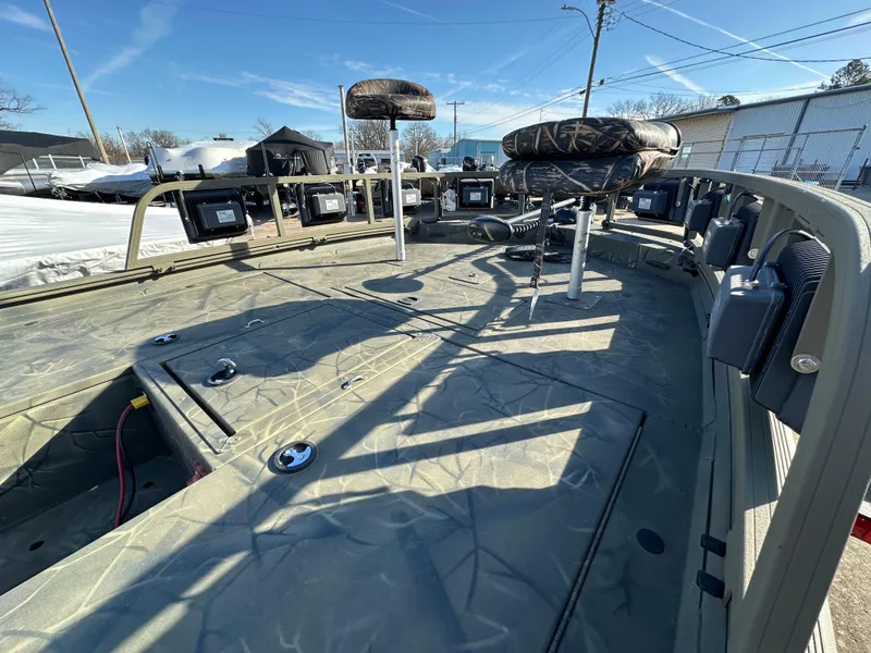 Slide: The Image of 2016 Tracker Grizzly 1760 MVX Sportsman boat interior with camo seats and storage compartments. - 5