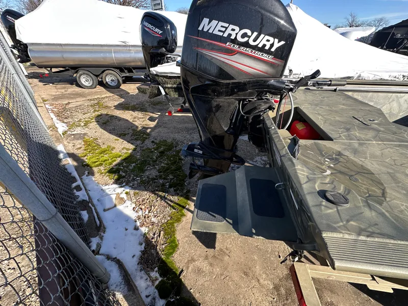 Slide: The Image of 2016 Tracker Grizzly 1760 MVX Sportsman with Mercury outboard motor, parked outdoors. - 7