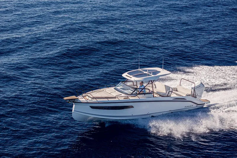 Slide: The Image of Navan S30 2025 motorboat cruising on open sea, showcasing sleek design and performance. - 12