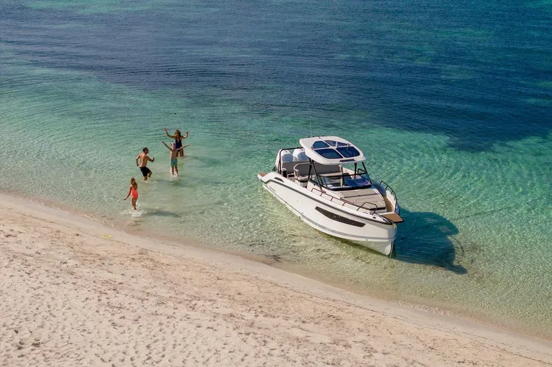 Slide: The Image of People enjoying beach near Navan S30 boat, 2025 model, in clear turquoise water. - 17