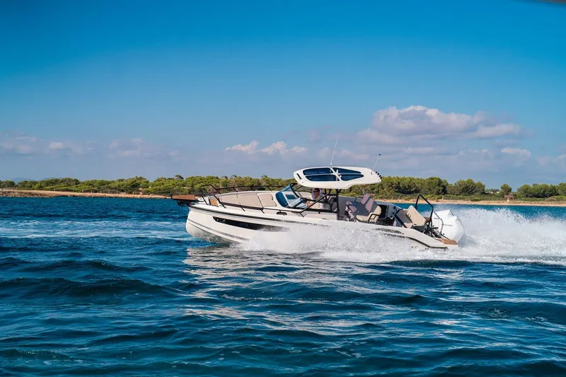 Slide: The Image of Family enjoying beach walk with Navan S30 boat in background, 2025. - 19