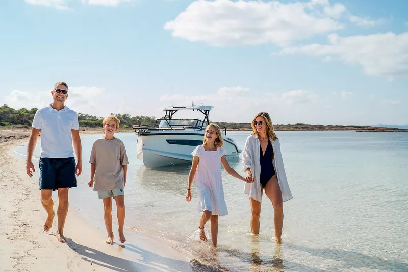 Slide: The Image of Navan S30 2025 motorboat cruising on open sea with passengers onboard. - 20