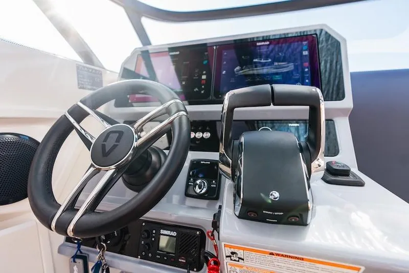 Slide: The Image of 2025 Navan S30 boat cockpit with modern steering and digital controls. - 23