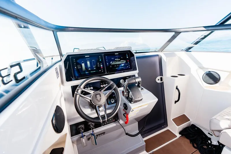 Slide: The Image of 2025 Navan S30 boat cockpit with modern steering and digital controls. - 24