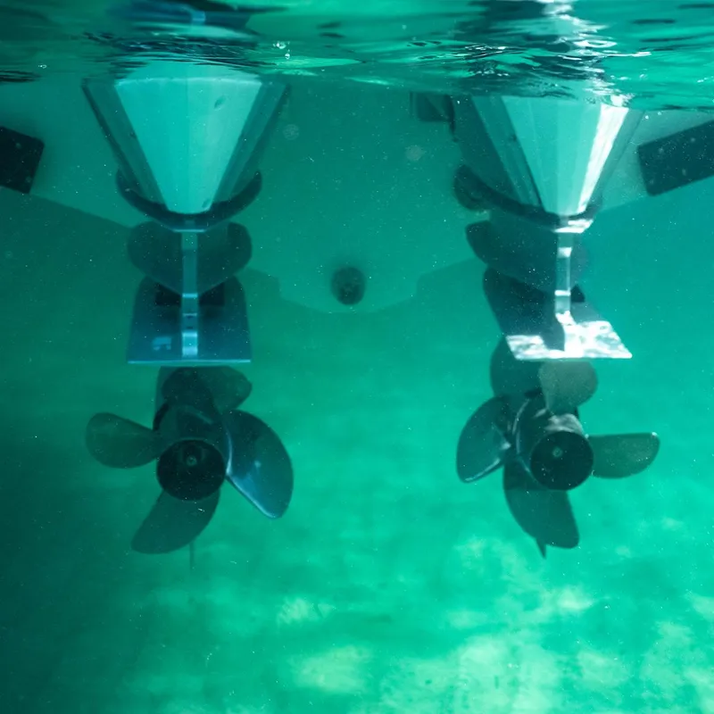 Slide: The Image of Navan S30 boat interior with seating and table, 2025 model, near rocky coastline. - 3