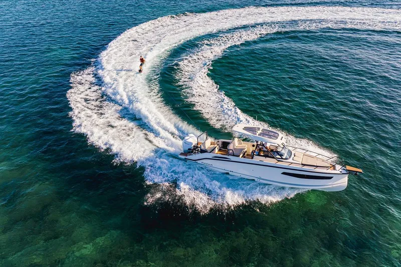 Slide: The Image of 2025 Navan S30 boat docked at night, illuminated by blue lights. - 30