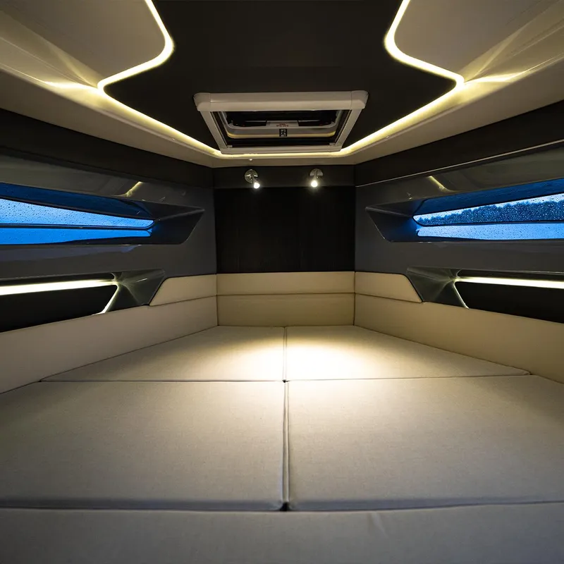 Slide: The Image of Navan S30 2025 boat with onboard bar, ice-filled cooler, and drink cans by the water. - 5