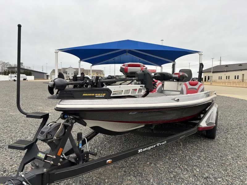 Slide: The Image of 2018 Ranger Z520L boat on trailer under blue canopy, parked on gravel. - 1