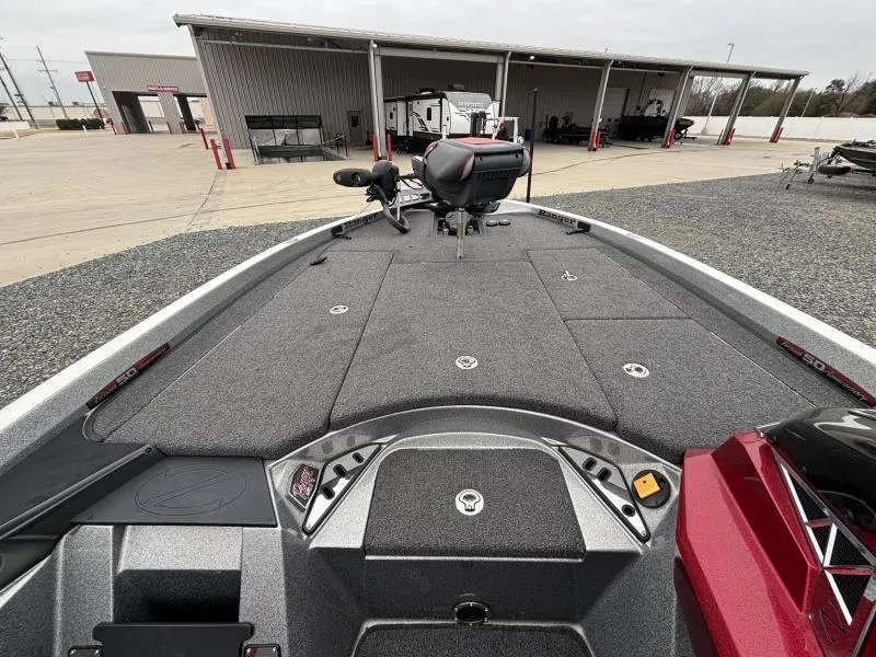Slide: The Image of 2018 Ranger Z520L boat deck with storage compartments and seating, parked near a building. - 15