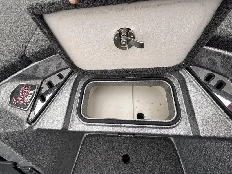 Slide: The Image of 2018 Ranger Z520L boat storage compartment with open lid and latch. - 16