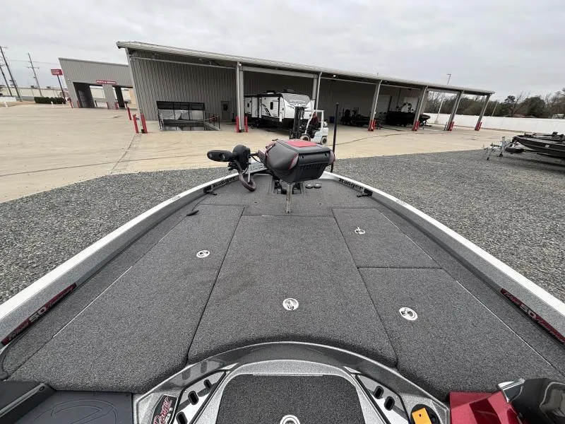 Slide: The Image of 2018 Ranger Z520L boat deck at a storage facility with trailers in the background. - 18