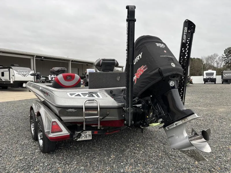 Slide: The Image of 2018 Ranger Z520L boat with Mercury engine, parked on gravel near RVs. - 5