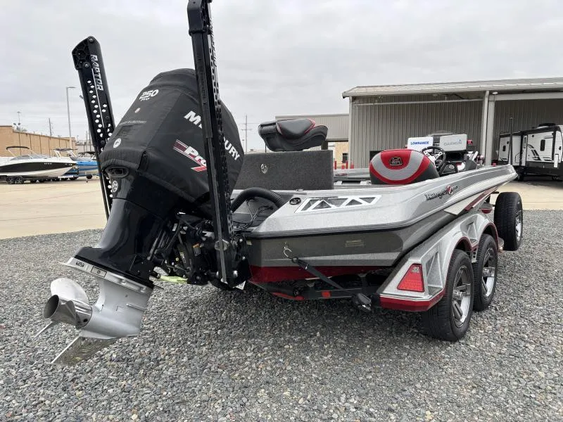 Slide: The Image of 2018 Ranger Z520L boat with Mercury engine, parked on gravel near a warehouse. - 6