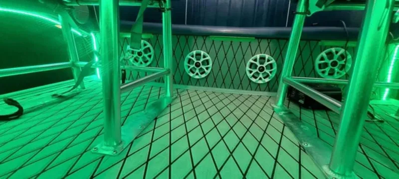 Slide: The Image of 1987 Chaparral Villan II boat interior with green LED lighting and diamond-patterned flooring. - 4