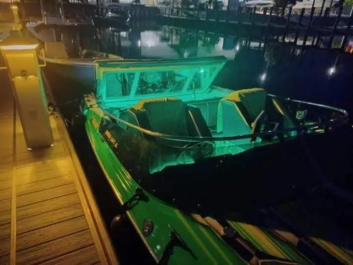 Slide: The Image of 1987 Chaparral Villan II boat docked at night with green interior lighting. - 6