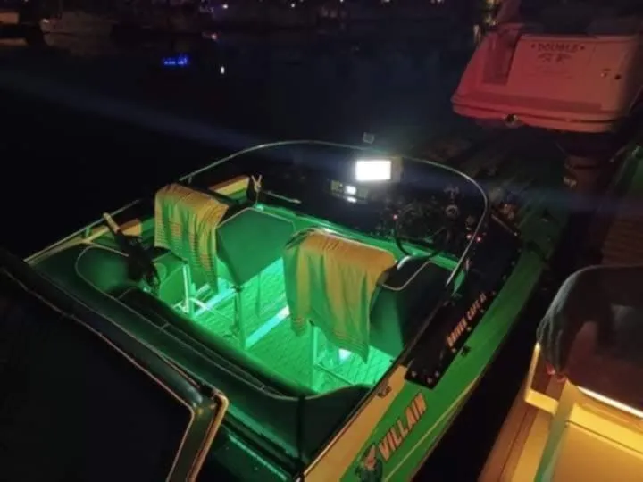 Slide: The Image of 1987 Chaparral Villan II boat with glowing green interior lights at night. - 9