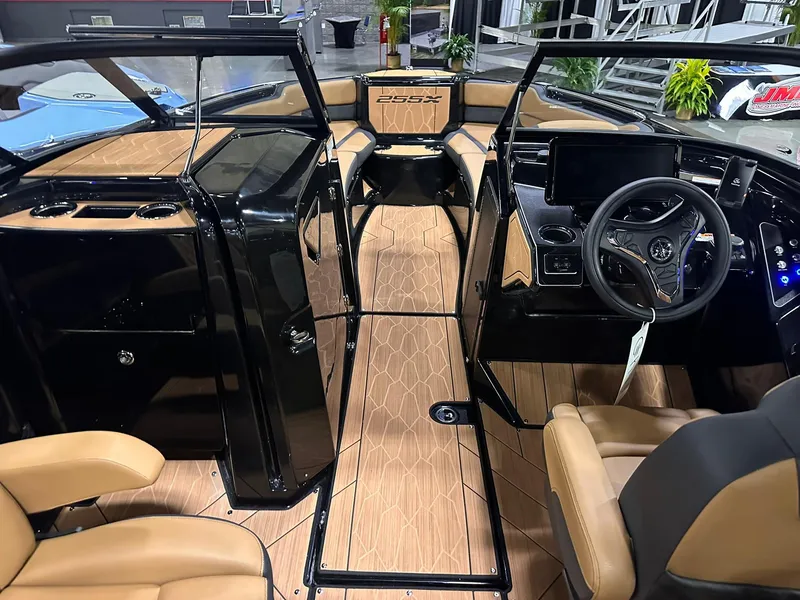 Slide: The Image of Interior view of 2025 Yamaha Boats 255XD, featuring sleek design and modern dashboard. - 11