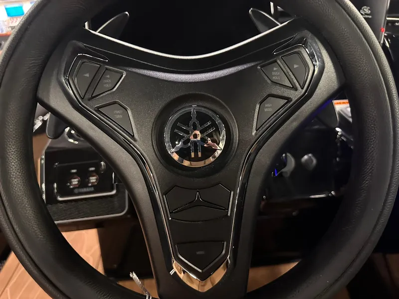 Slide: The Image of Steering wheel of 2025 Yamaha Boats 255XD, featuring modern controls and sleek design. - 12