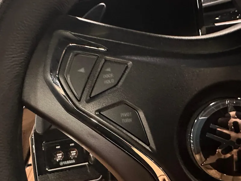 Slide: The Image of Steering wheel controls of 2025 Yamaha Boats 255XD, featuring sleek design and functionality. - 13
