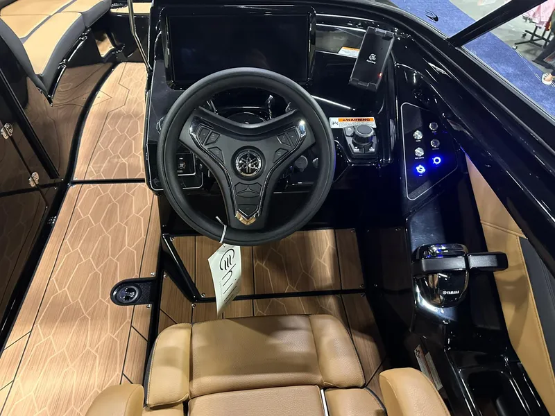 Slide: The Image of 2025 Yamaha Boats 255XD cockpit with modern steering wheel and control panel. - 14