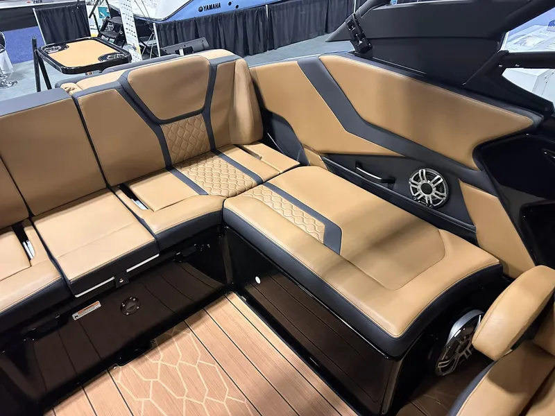Slide: The Image of Luxurious interior of 2025 Yamaha Boats 255XD with tan and black seating. - 18