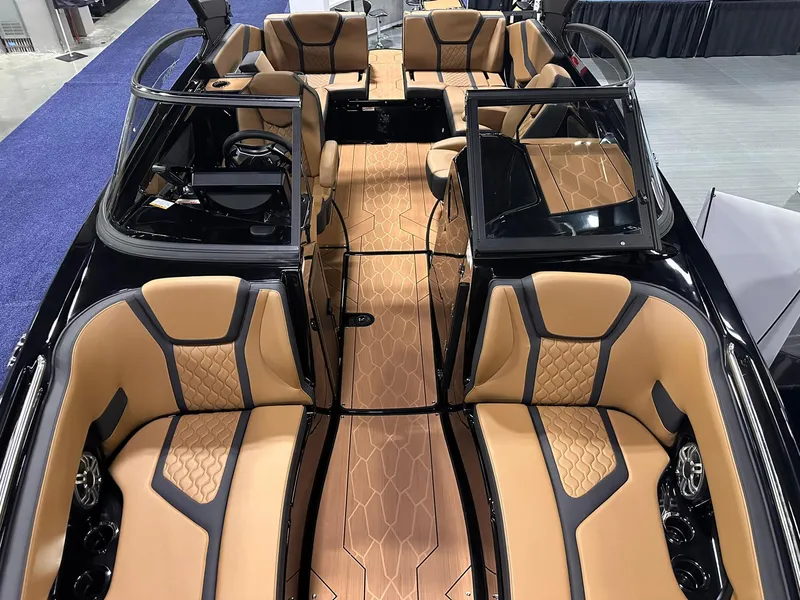 Slide: The Image of 2025 Yamaha Boats 255XD interior with luxurious tan and black seating, elegant wood flooring. - 23