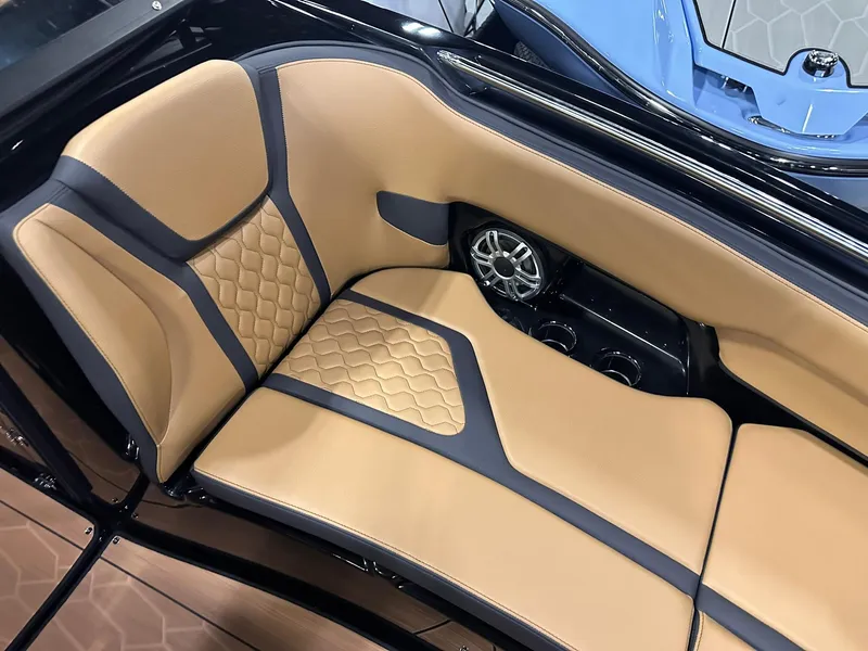 Slide: The Image of Luxurious tan seating in 2025 Yamaha Boats 255XD, featuring stylish design and integrated speaker. - 26