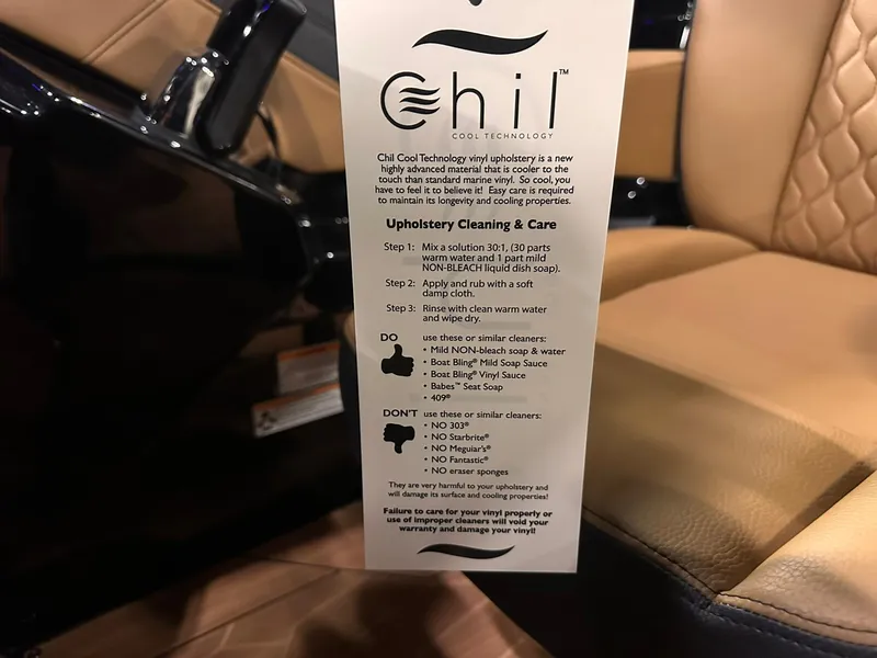 Slide: The Image of Yamaha Boats 255XD 2025 interior with Chil upholstery care instructions tag. - 28