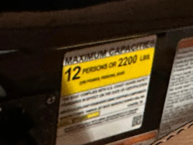 Slide: The Image of Capacity label on 2025 Yamaha Boats 255XD, indicating 12 persons or 2200 lbs. - 29