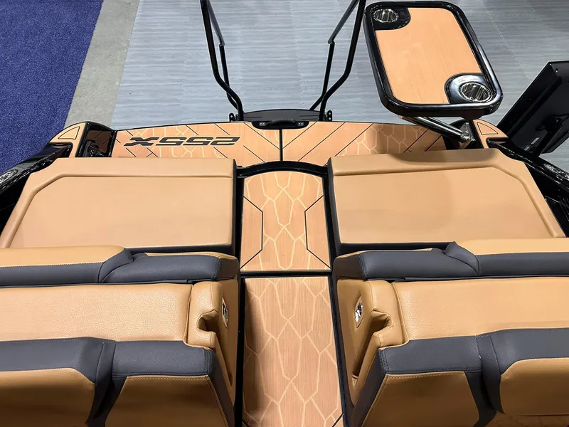 Slide: The Image of 2025 Yamaha Boats 255XD interior with tan and black seating, featuring a sleek design. - 32