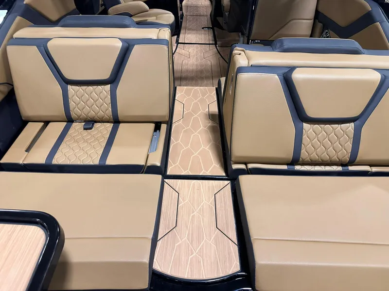 Slide: The Image of 2025 Yamaha Boats 255XD interior with tan and black seating, featuring modern design and wood accents. - 7