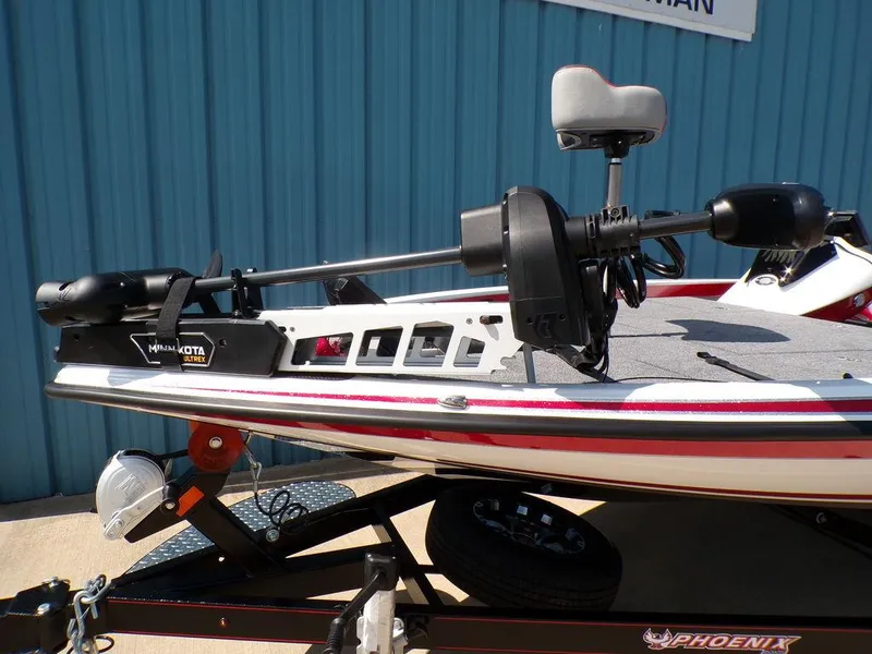 Slide: The Image of Red Phoenix 920 Elite 2025 boat deck with gray carpeting and storage compartments. - 15