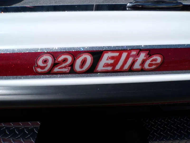 Slide: The Image of Open storage compartment in 2025 Phoenix 920 Elite boat, featuring hydraulic struts and carpeted interior. - 16