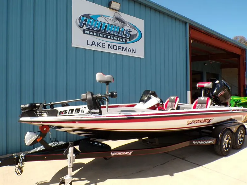 Slide: The Image of 2025 Phoenix 920 Elite boat interior with red and gray diamond-stitched seats. - 22